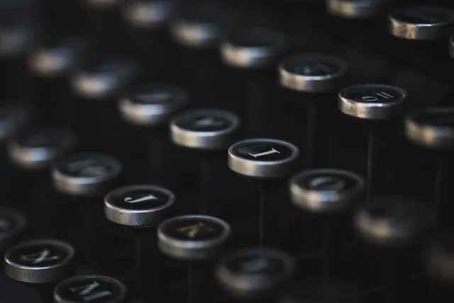 typewriter, vintage, keyboard, letter, writing, business, office, dark, mood, black, old, antique, retro, typewriter, typewriter, keyboard, writing, writing, writing, writing, writing, business, office. Create company descriptions that match the whole plan